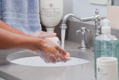 Woman Lathering Hands in Bathroom Sink HR Kinetico 50 Years Celebration | Integrity Water Solutions