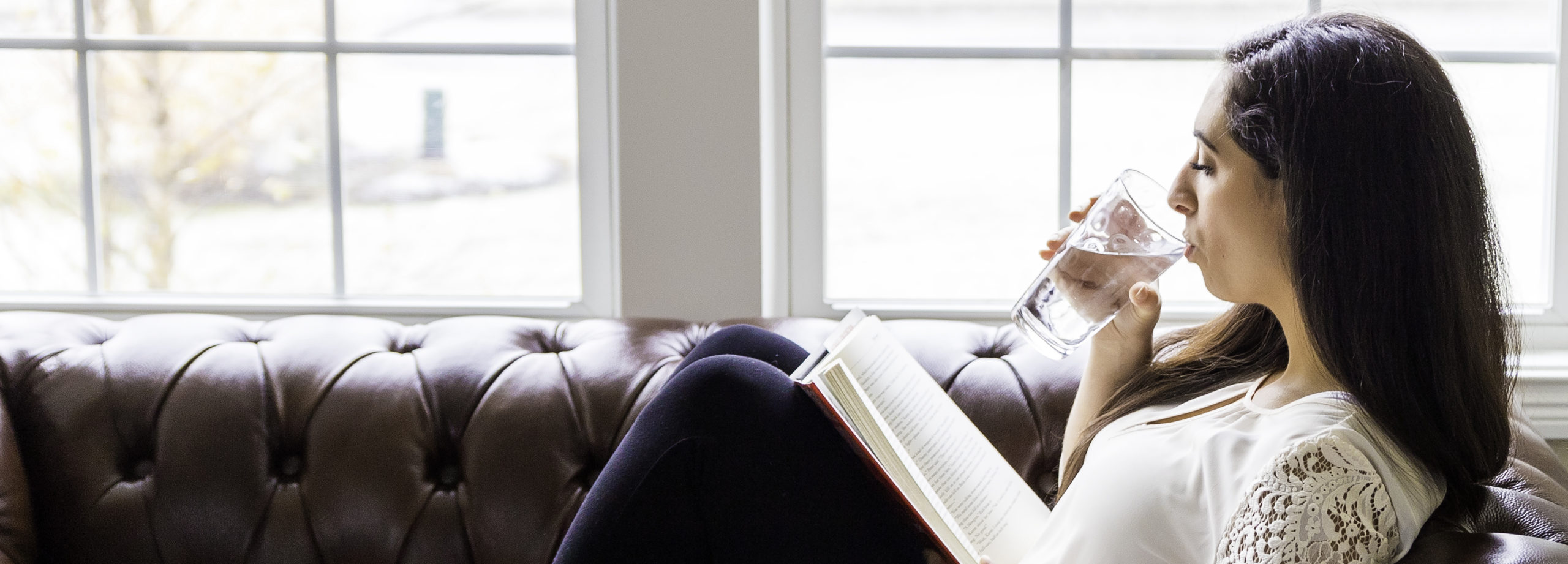 Woman Sipping Water On Couch